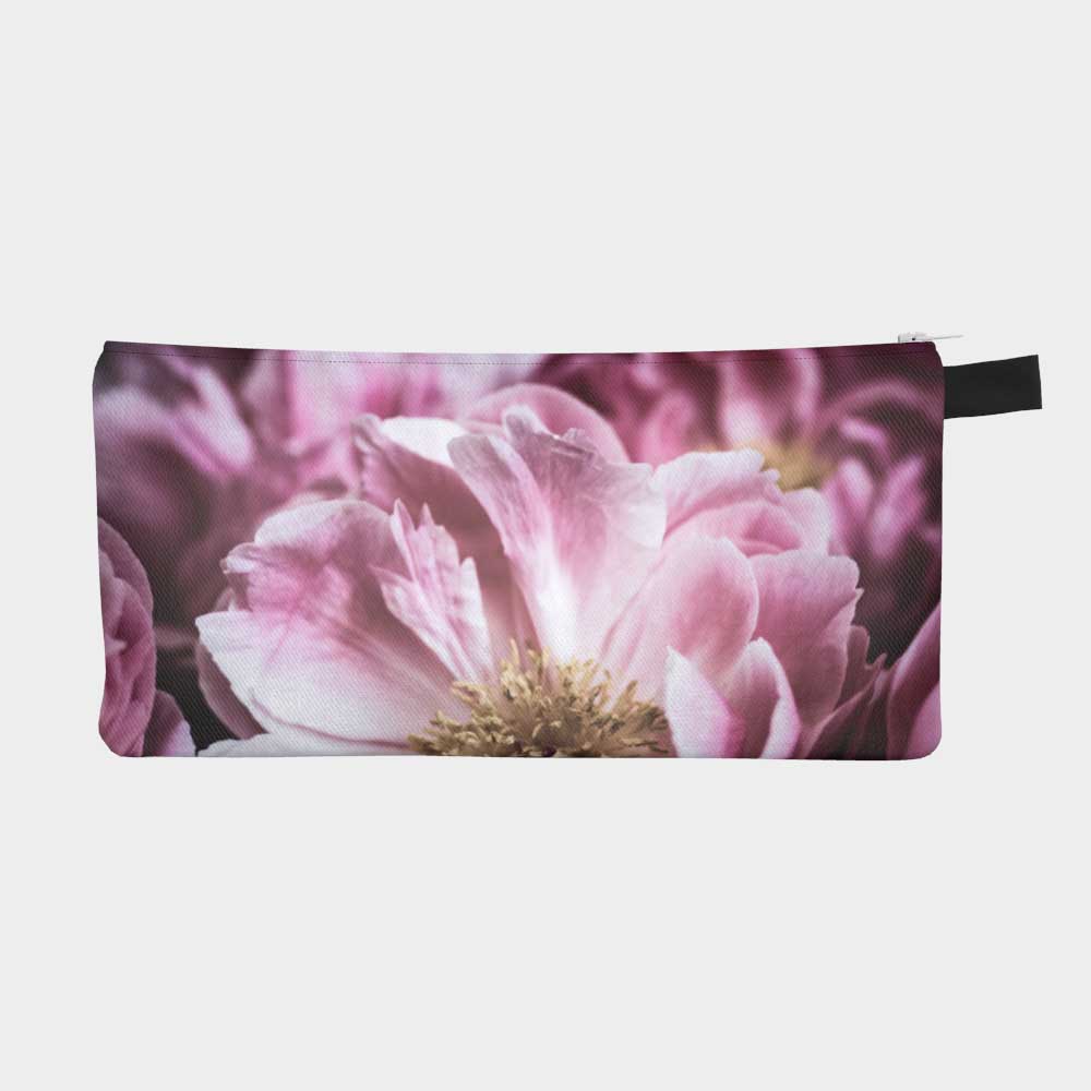 Close-up of zippered pouch of vibrant magenta peony flower, front view.