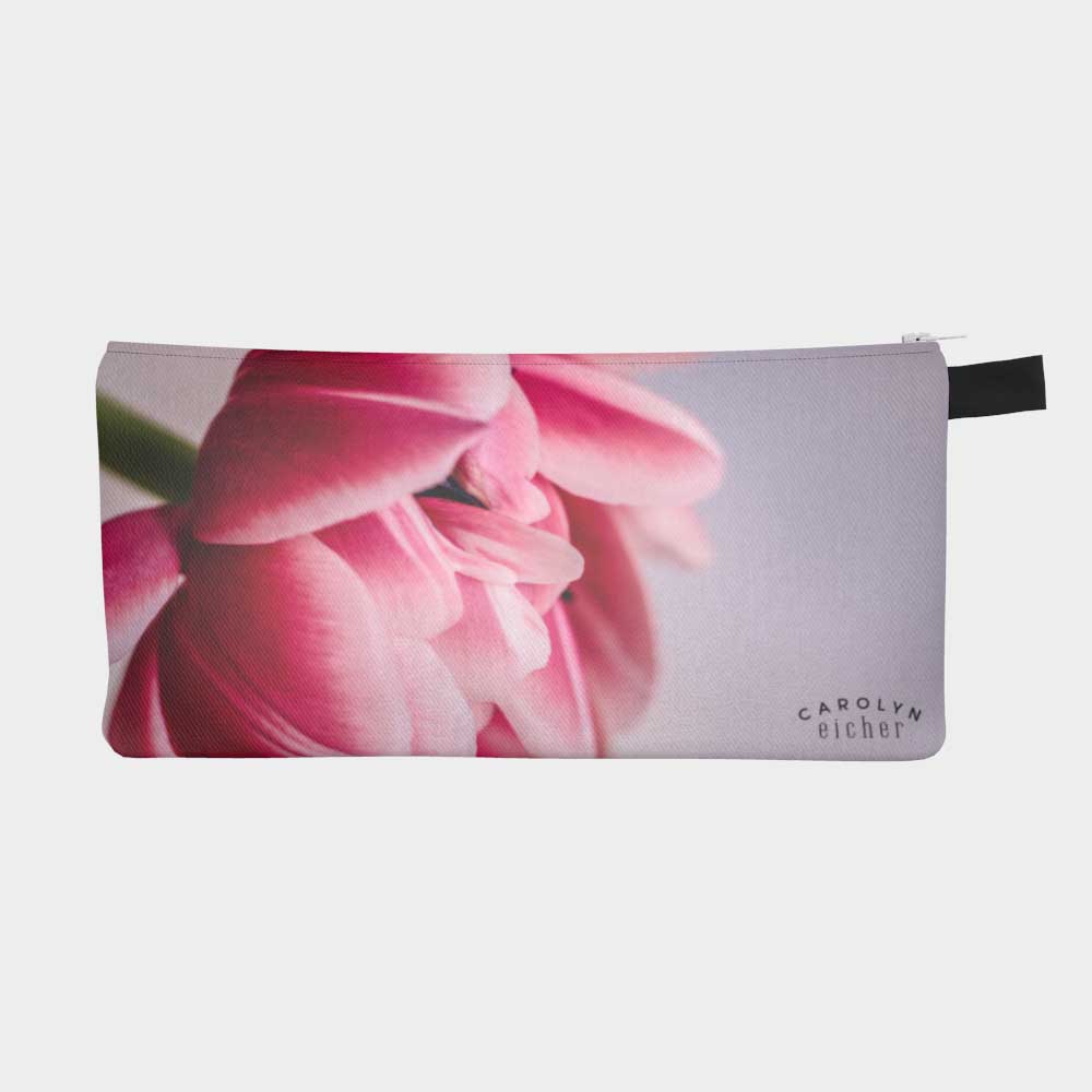 Zippered pouch with close-up image of vibrant pink tulip flower, front view.  