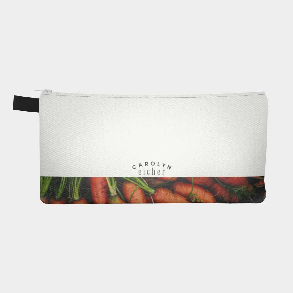 Close-up of the back of zippered pouch with lower part of pouch showing carrots from the farmers' market. 