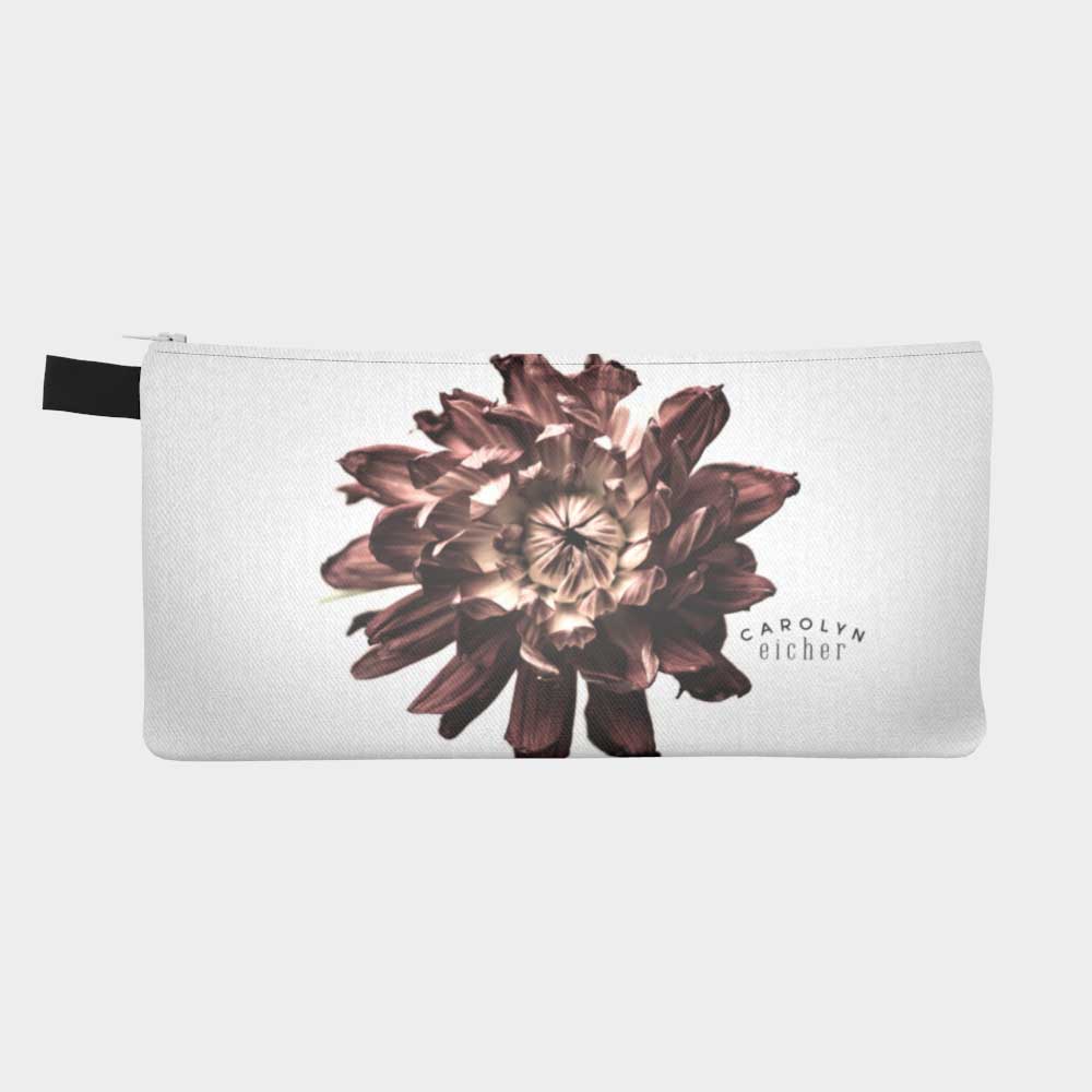 Close-up of a zippered pouch with a desaturated dahlia flower.